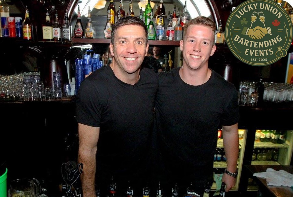 Lucky Union bartenders smiling behind a fully stocked bar